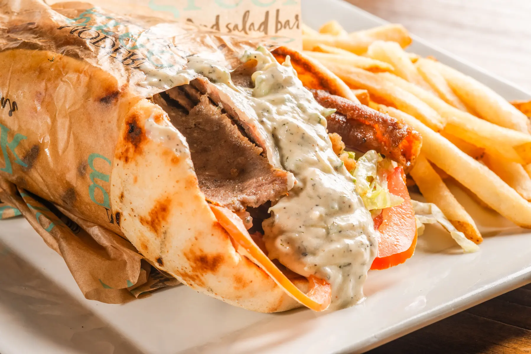 A plate of food with fries and meat on it.